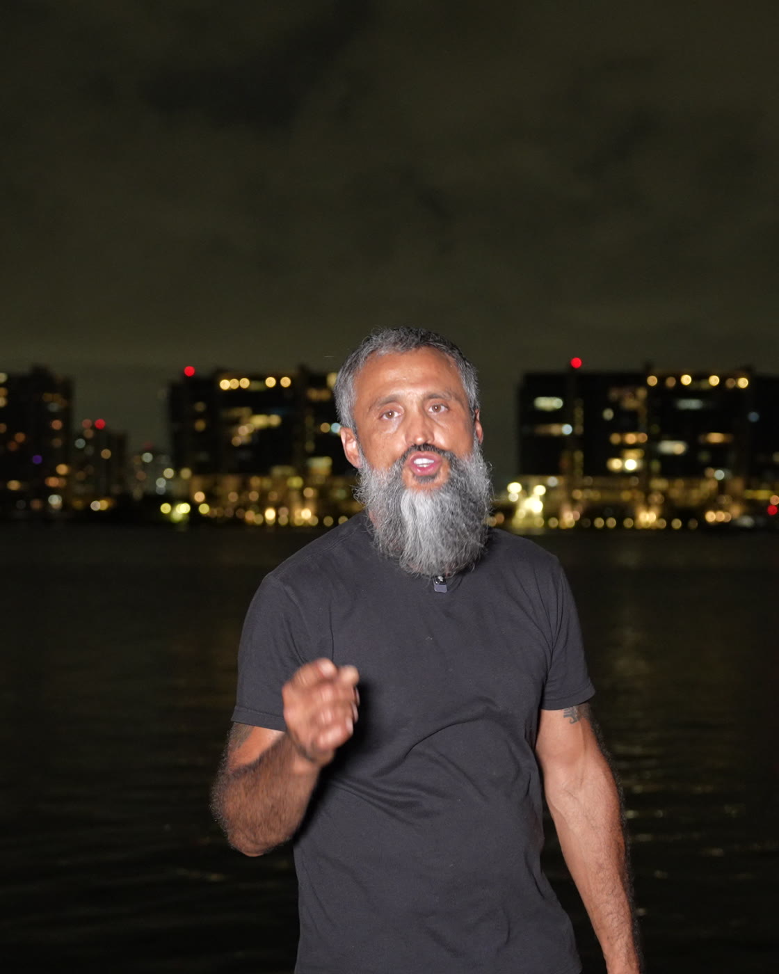 Gennady MC, founder of Anonymous Media, on the Miami waterfront at night